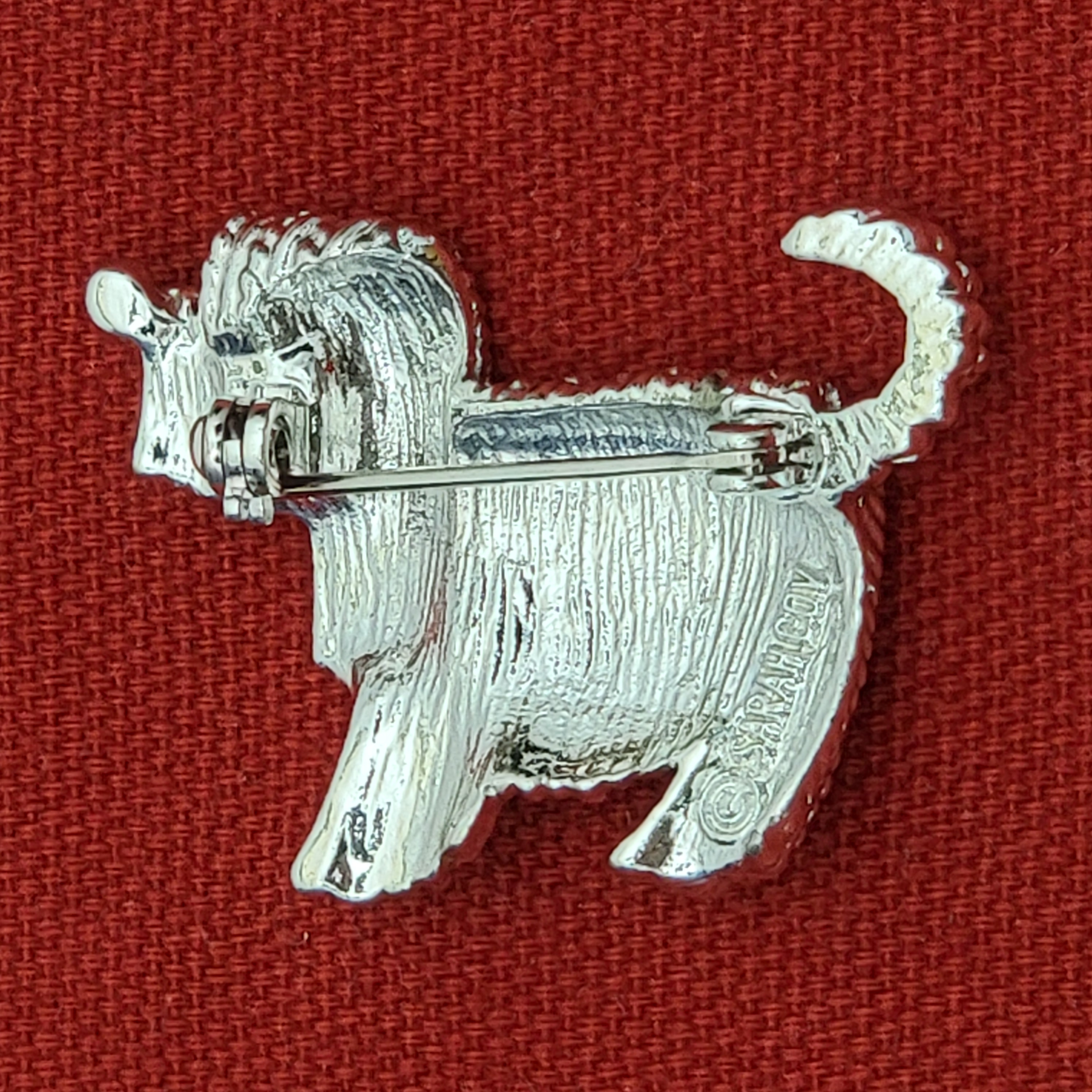 Dog brooch inscription close-up